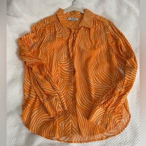 Bailey/44 orange and white pattern long sleeved blouse.